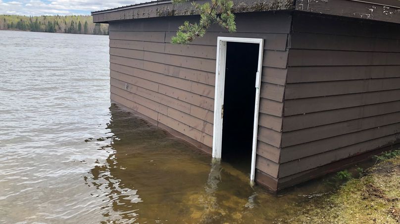 Flooded boathouse sits on the shore of the Winnipeg River.