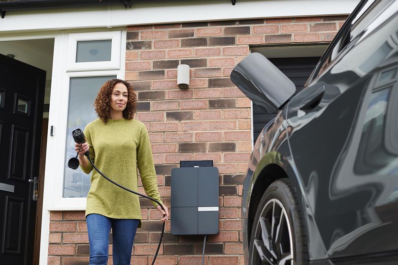 An electric vehicle and charger at someone’s home